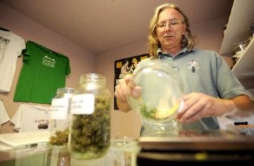 Grateful Meds Mark Rose, owner of the Grateful Meds dispensary in Nederland, weighs out an eighth of an ounce of medical marijuana for a client.